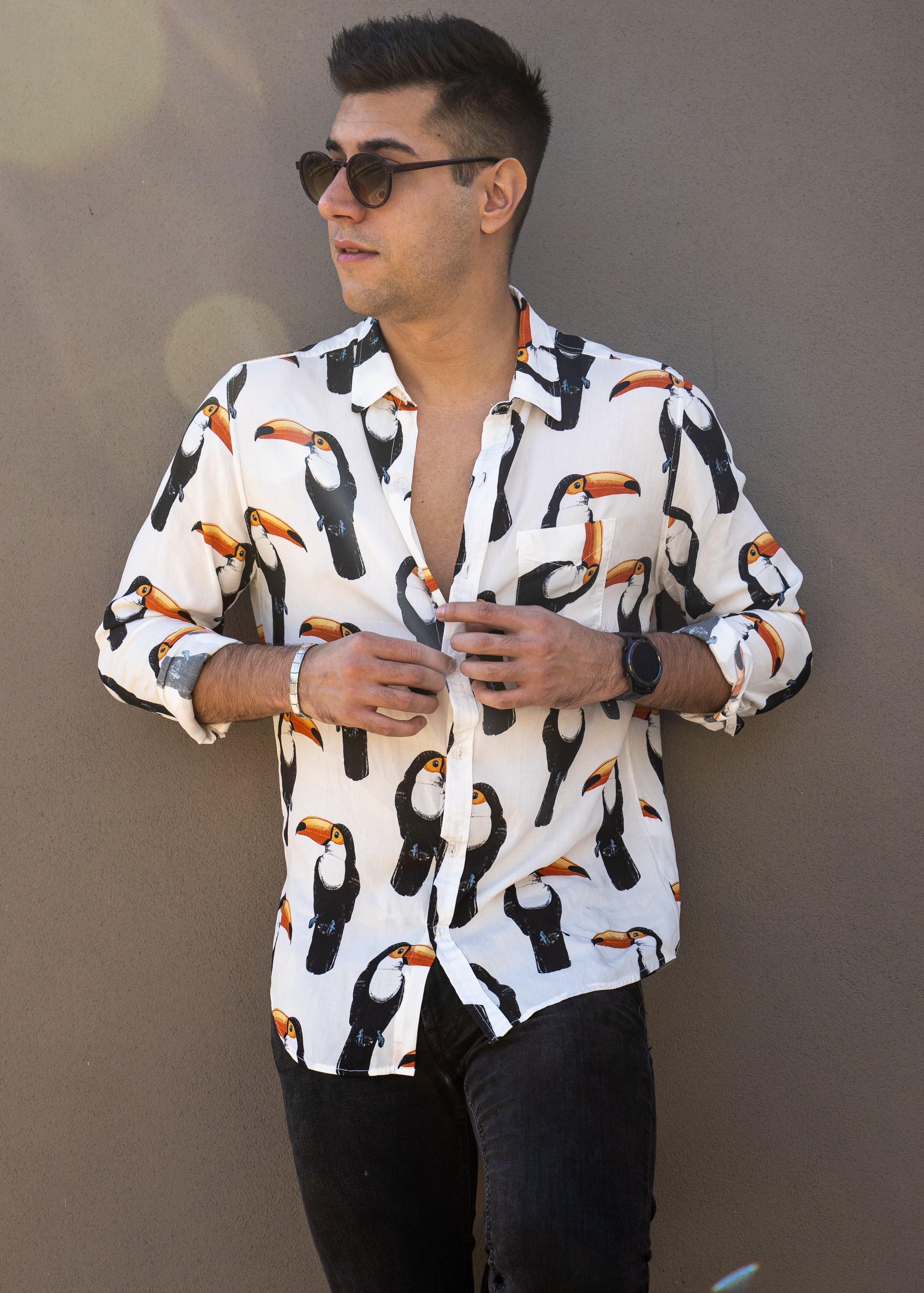 Long Sleeve Shirt - ToucanStrange ParadiseStrange Paradise
Men's Long Sleeve Shirt - Toucan Do It is a slim fit shirt with button up fastening and a single chest pocket. The shirt showcases a smart casual look and is pairedMen's Long Sleeve Shirt - Toucan Do It