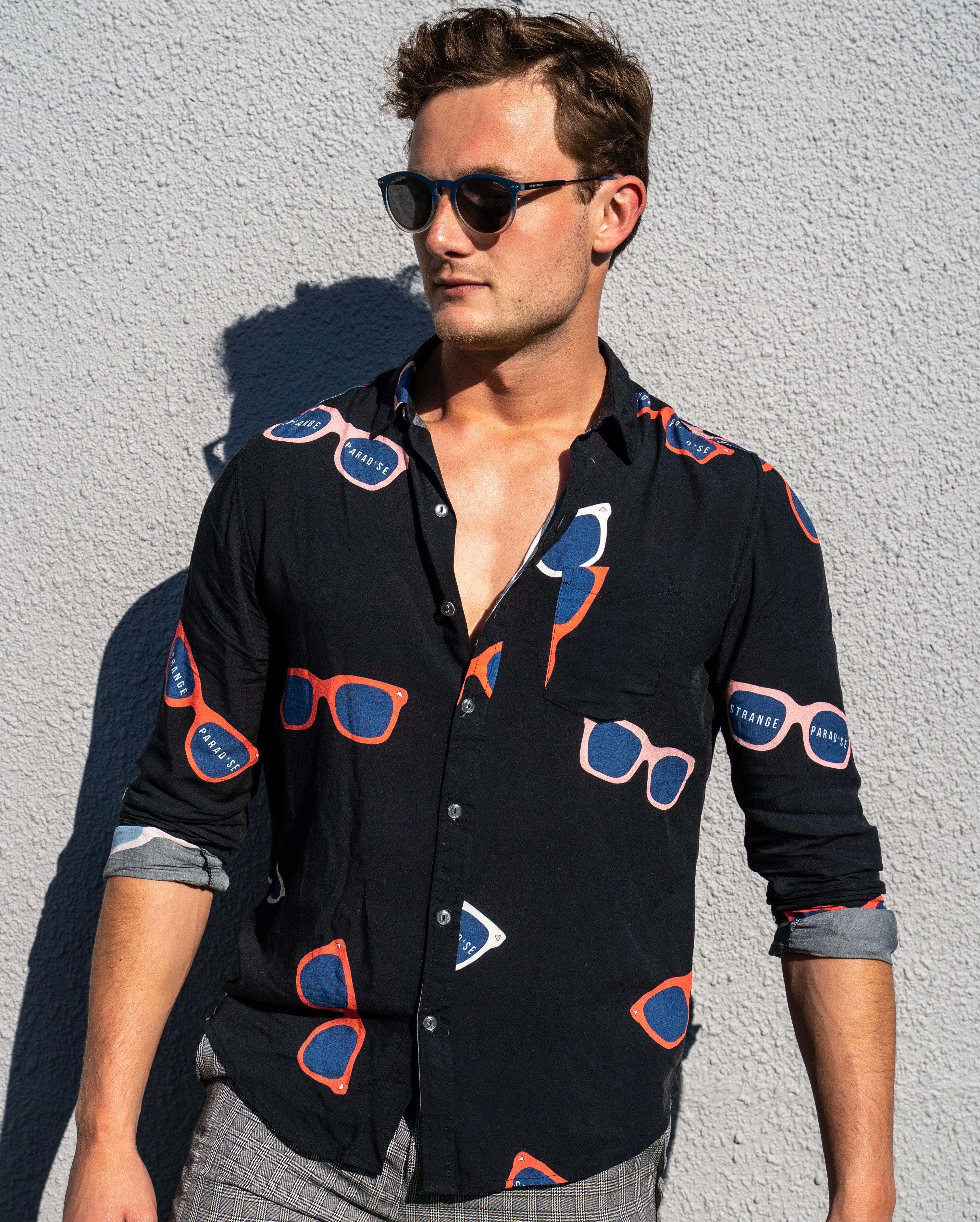 Long Sleeve Shirt - Retro ShadesStrange ParadiseStrange Paradise
Men's Long Sleeve Shirt - Retro Shades is a slim fit shirt with button up fastening and a single chest pocket. The shirt showcases a smart casual look and is pairedMen's Long Sleeve Shirt - Retro Shades