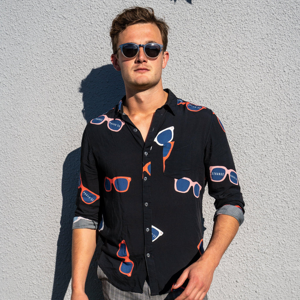 Long Sleeve Shirt - Retro ShadesStrange ParadiseStrange Paradise
Men's Long Sleeve Shirt - Retro Shades is a slim fit shirt with button up fastening and a single chest pocket. The shirt showcases a smart casual look and is pairedMen's Long Sleeve Shirt - Retro Shades