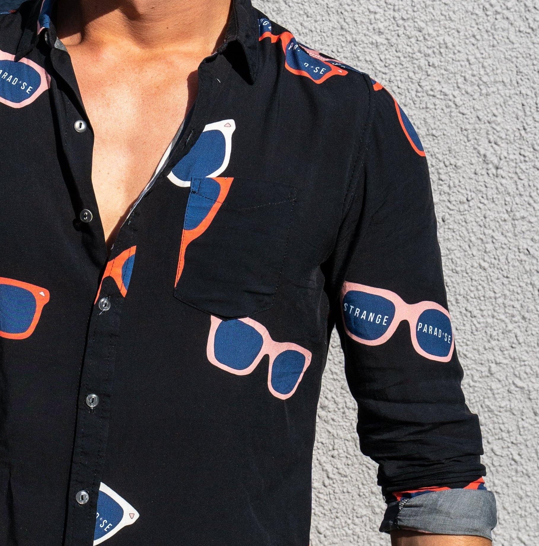 Long Sleeve Shirt - Retro ShadesStrange ParadiseStrange Paradise
Men's Long Sleeve Shirt - Retro Shades is a slim fit shirt with button up fastening and a single chest pocket. The shirt showcases a smart casual look and is pairedMen's Long Sleeve Shirt - Retro Shades