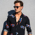 Long Sleeve Shirt - Retro ShadesStrange ParadiseStrange Paradise
Men's Long Sleeve Shirt - Retro Shades is a slim fit shirt with button up fastening and a single chest pocket. The shirt showcases a smart casual look and is pairedMen's Long Sleeve Shirt - Retro Shades